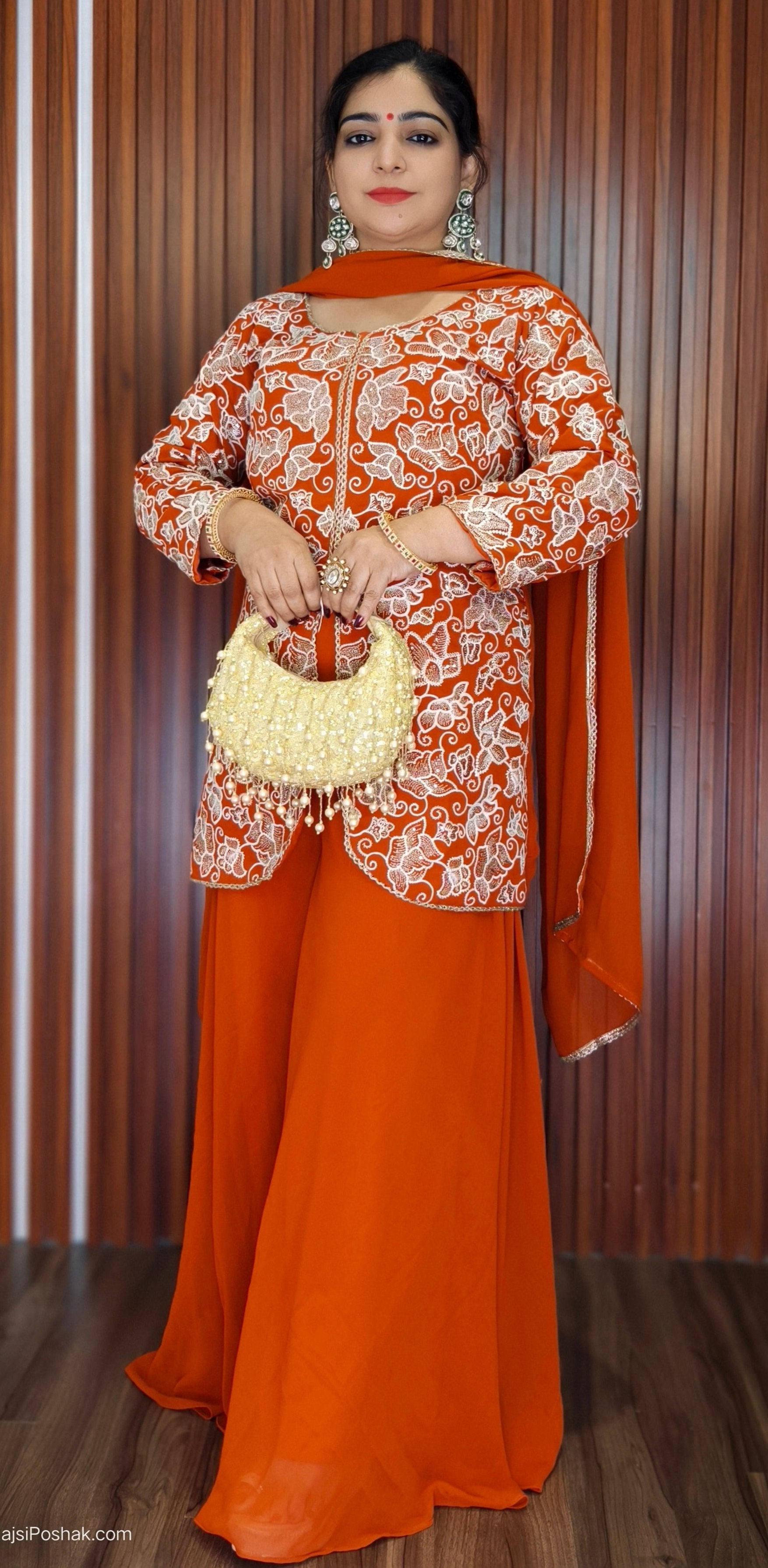 ORANGE DIVIDER SUIT FEATURING INTRICATE ALL-OVER ZARDOZI AND MOTI EMBROIDERY ON THE SHIRT, WITH MATCHING BOOTIES SCATTERED ACROSS THE ENTIRE DUPATTA